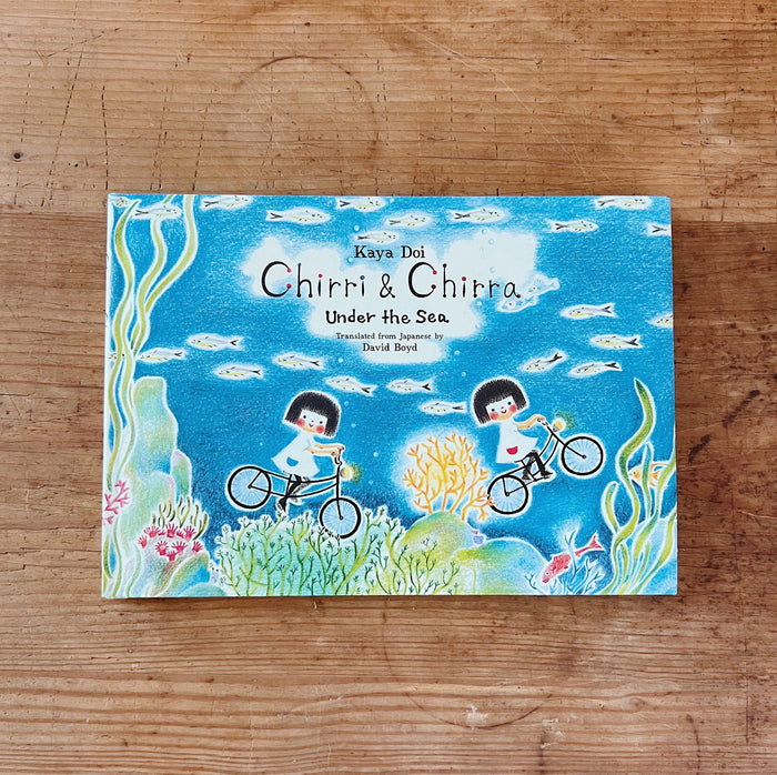 Hardcover book cover of 'Chirri & Chira: Under the Sea' featuring illustration of two characters on bicycles in an underwater scene with coral and fish.