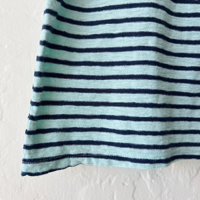 Close-up of a striped fabric with blue and white horizontal lines on a plain background
