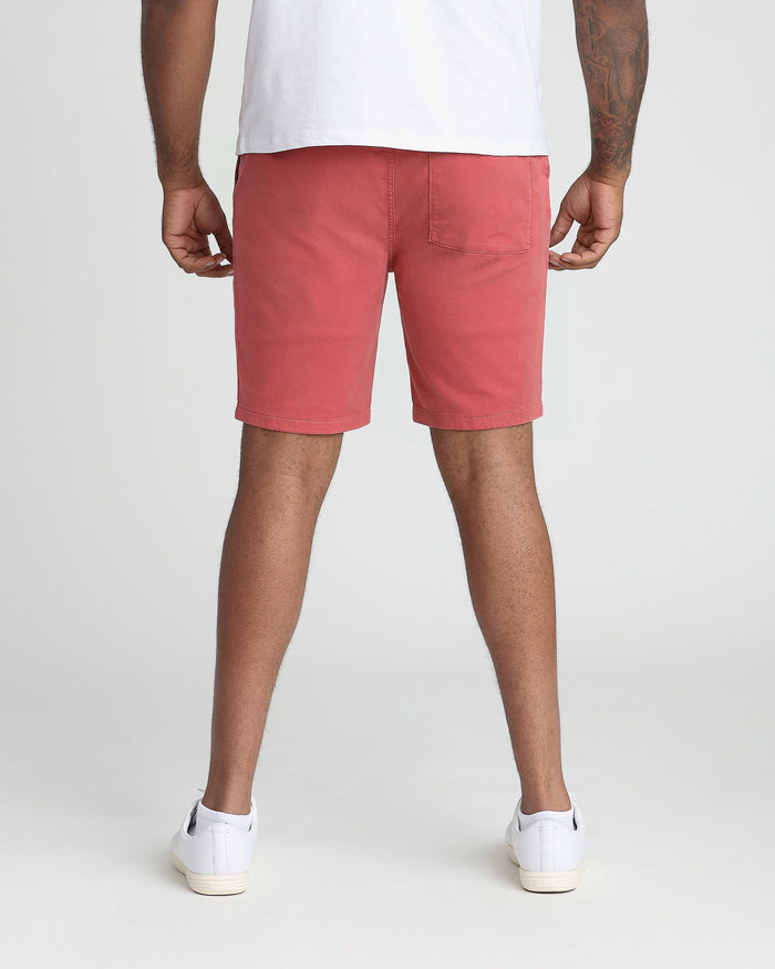 Nantucket red athletic fit shorts with back pocket, worn with white t-shirt and sneakers.