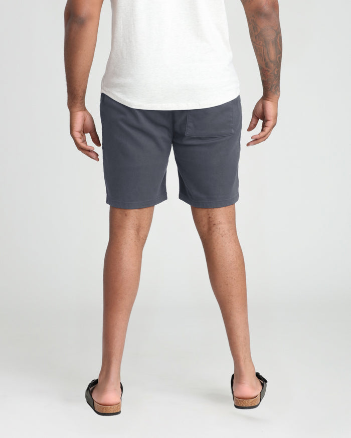 Slate-colored athletic fit shorts on a man wearing a white t-shirt, shown from front and back views.