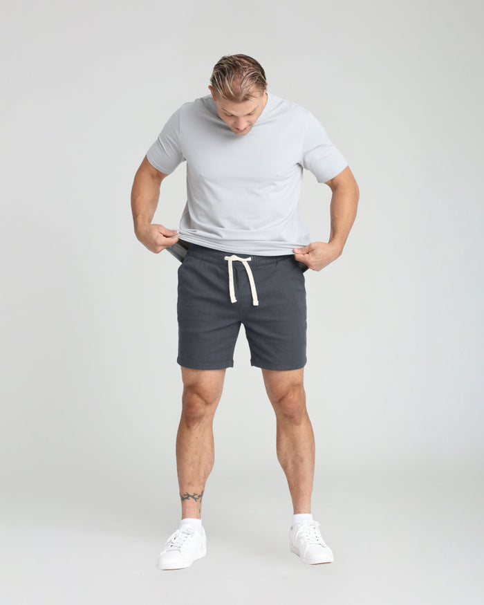 Slate slim fit shorts with drawstring waist, shown paired with white t-shirt and sneakers.