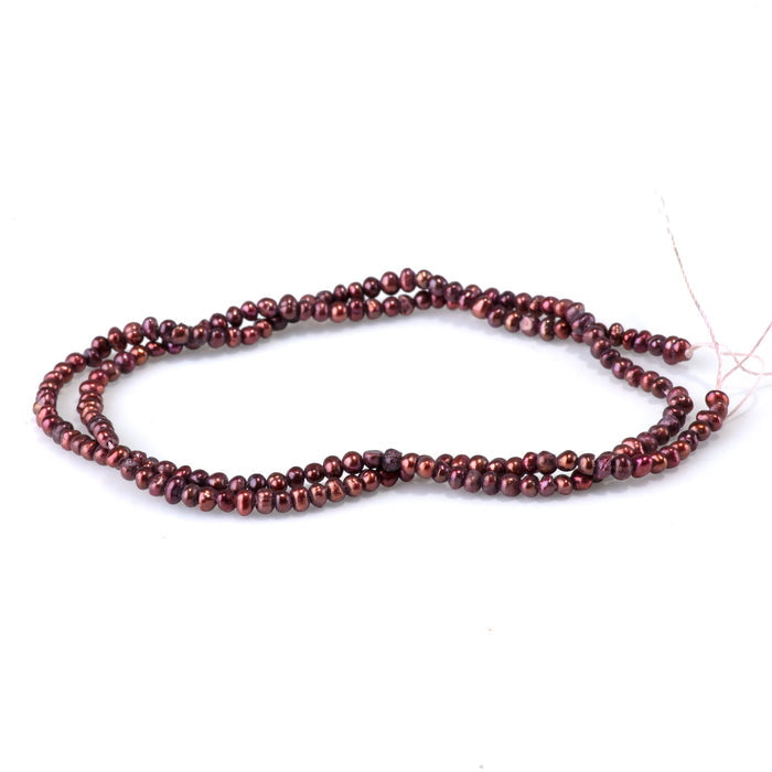 This is a Dakota Stones 2-5mm Freshwater Pearl Burgundy Potato Gemstone strand of round beads in 15-16 inch strand.