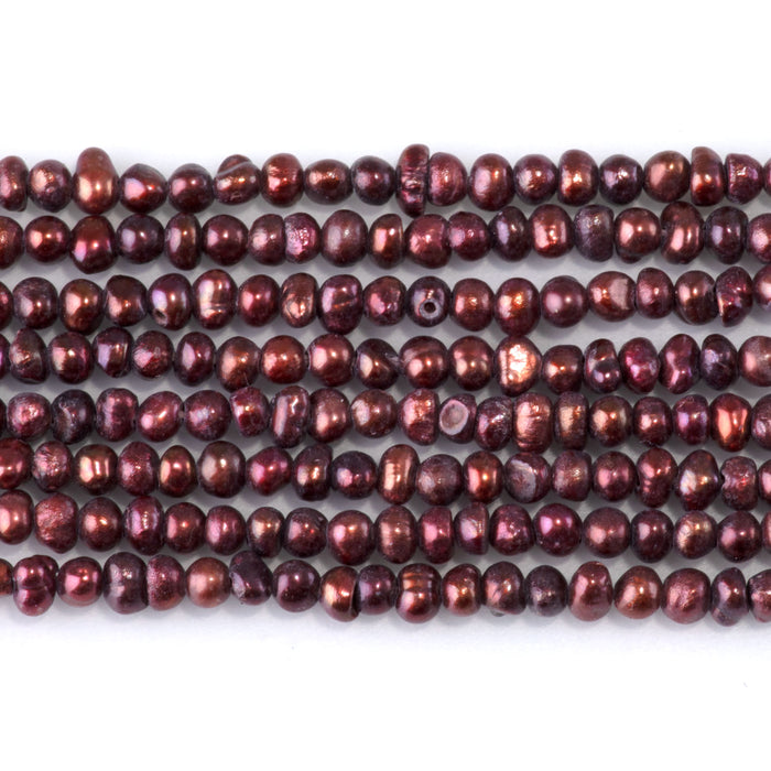 This is a Dakota Stones 2-5mm Freshwater Pearl Burgundy Potato Gemstone strand of round beads in 15-16 inch strand.