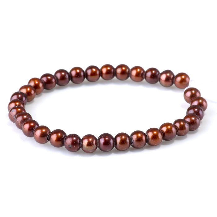 This is a Dakota Stones 6-7mm Freshwater Pearl Red Brown Gold Gemstone strand of round beads in 8 inch strand.
