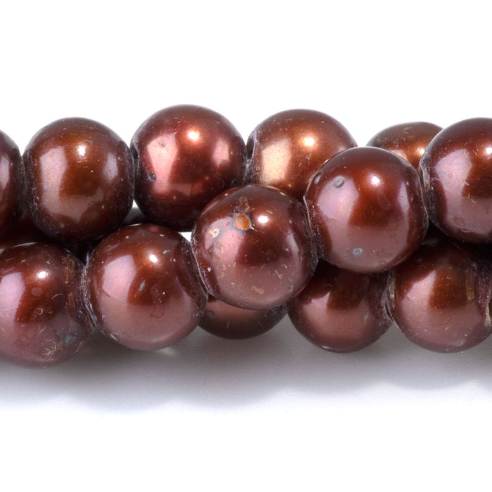 This is a Dakota Stones 6-7mm Freshwater Pearl Red Brown Gold Gemstone strand of round beads in 8 inch strand.