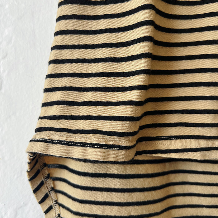 Close-up of a beige fabric with black stripes on a white background