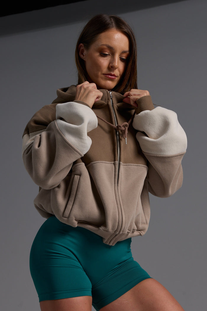 Hip length, full zip hoodie, with ribbed panels, embossed sleeve logo, in a slouchy oversize fit, with 2 convenient zip pockets, in mocha, stone and beige