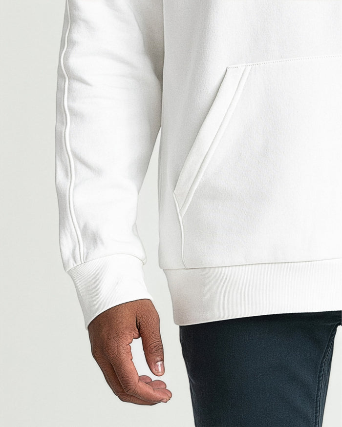 Cream-colored hoodie with ribbed cuffs and hem, shown on a person wearing dark pants.