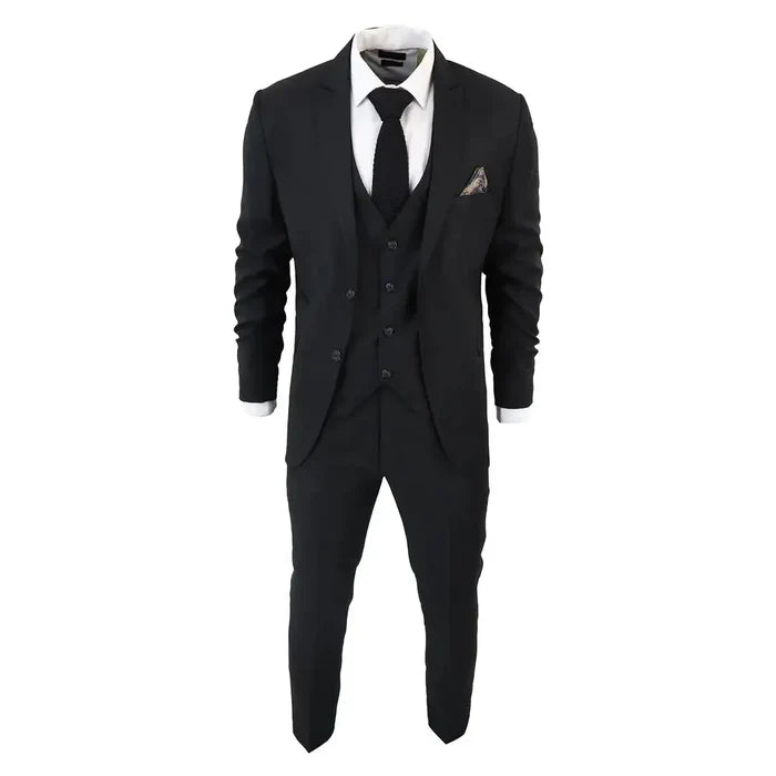 Close-up of men's black suit with a tailored blazer, vest, and white shirt, featuring a black tie and pocket square for elegant formal wear.