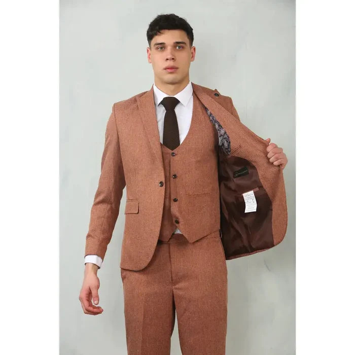 Male model in a brown tailored suit with vest and dress pants, white shirt, and black shoes, showcasing a sophisticated formal look.