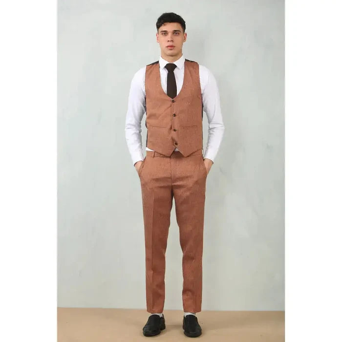 Back view of a man wearing a brown dress vest and matching pants, with a white shirt underneath, demonstrating a classic formal outfit.