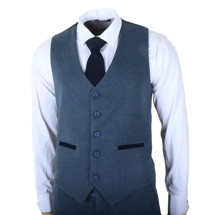 Men's blue tweed vest with notch lapel, four-button front, and tailored fit, paired with a white dress shirt and navy tie for formal wear.