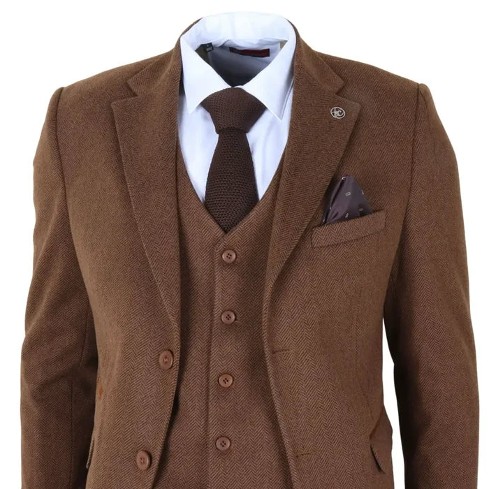 Silver lapel pin on brown tweed men's suit jacket, with white shirt and dark brown knitted tie, highlighting formal attire details