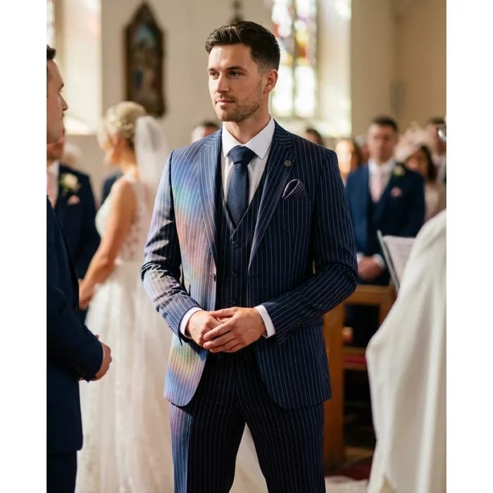 Men's navy blue pinstripe suit with slim fit, featuring a blazer, matching waistcoat, and trousers, styled with a white shirt and dark tie for wedding or business events.