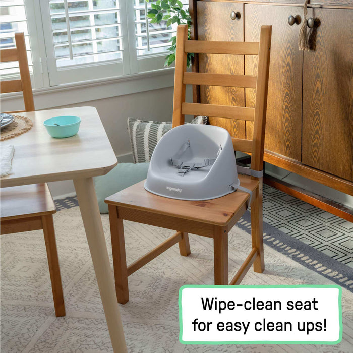 Grey Ingenuity My Spot Easy-Clean Baby Booster Seat with 3-point harness on dining chair