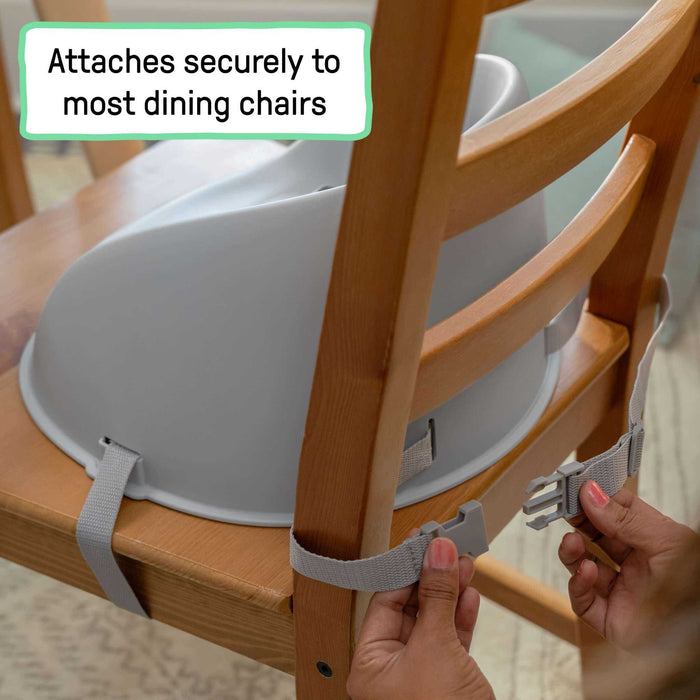 Grey Ingenuity My Spot Easy-Clean baby booster seat with 3-point harness on dining chair