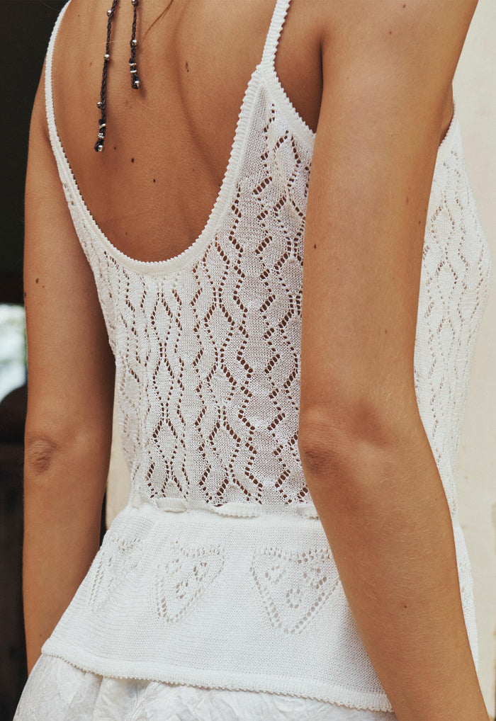 Back view of scoop neckline and diamond pointelle knit pattern on vintage cream cami, styled with matching skirt