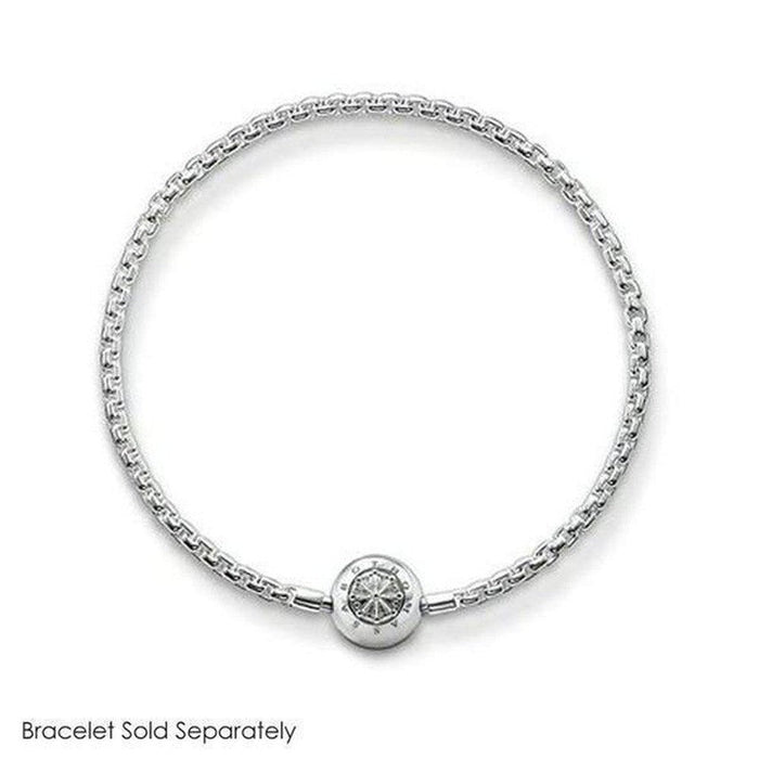 Silver charm with sun design, attached to a delicate chain bracelet.