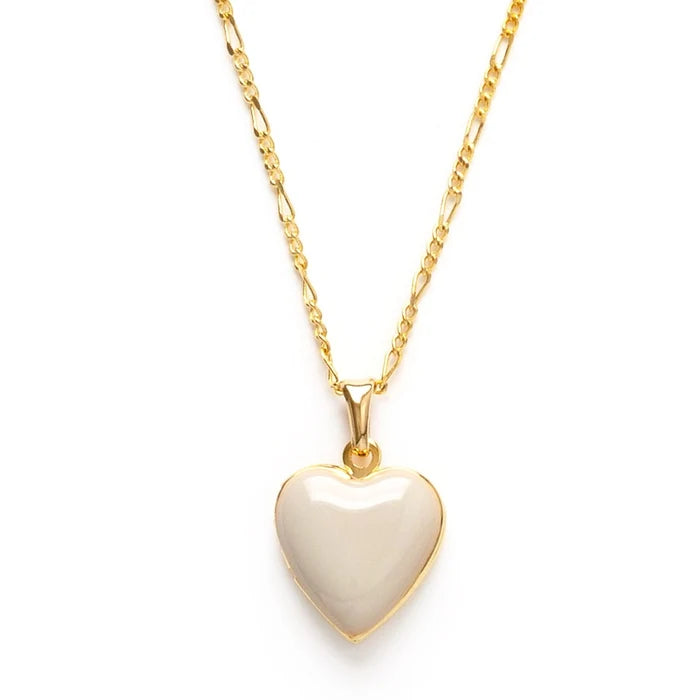 A beige heart-shaped locket on a gold-colored chain.