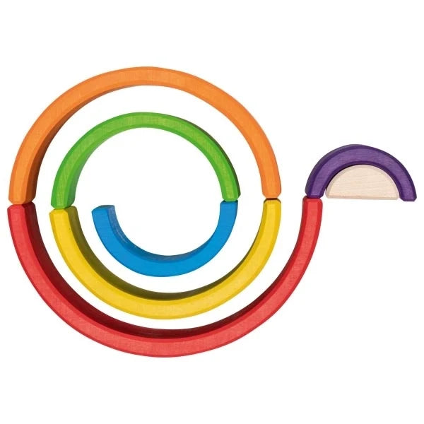 Goki Little Rainbow Building Blocks arranged in a flat spiral on a white background, with the arches laid end-to-end in a coil showing all 7 rainbow colors, with the smallest purple and natural wood pieces placed separately to the right