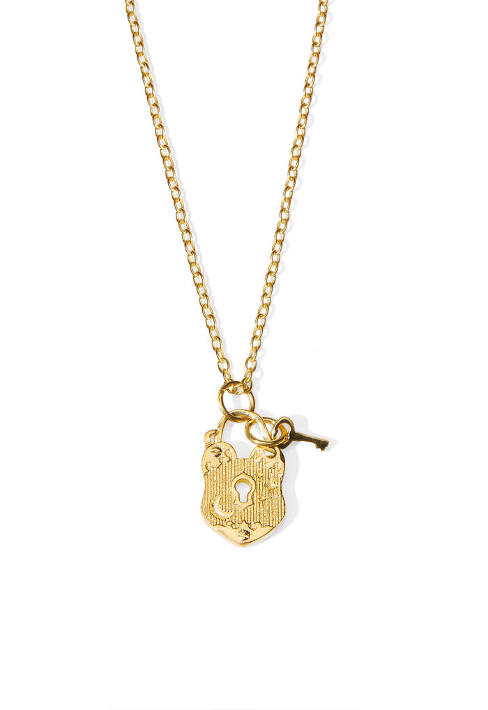 Gold-plated brass love lock charm necklace with engraved padlock and key pendant on fine chain, white background