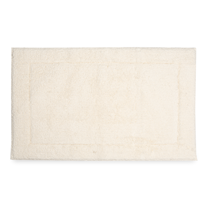Crafted in a century-old mill in Portugal, this 100% cotton bath rug is fully reversible.