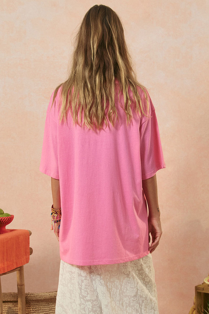 Back view of a model Piccola Oversized Biker Tee in Cosmos Pink, showing relaxed drop-shoulder fit