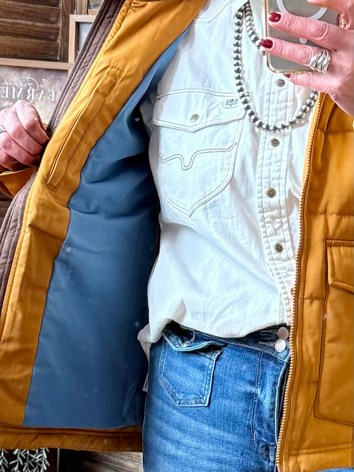 Mustard quilted coat open at front, showing teal interior lining and zip placket