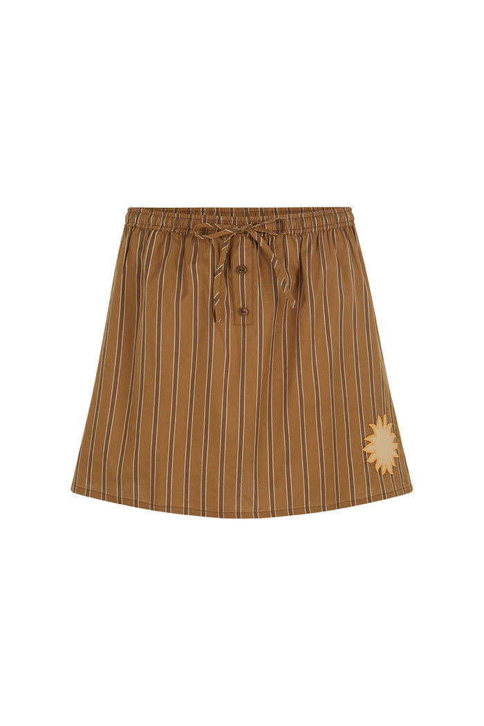 Caramel stripe organic cotton mini skirt, front flat lay showing button placket, drawstring waist, and sun applique detail