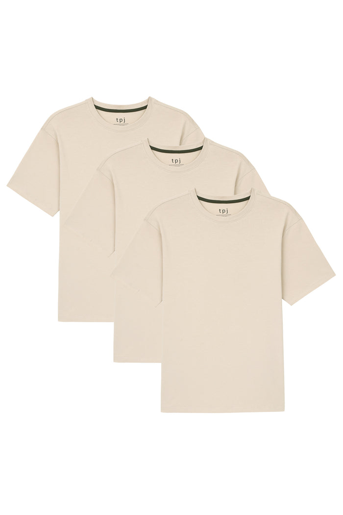 Three tan crew neck t-shirts with short sleeves and dark stripe trim at neckline.