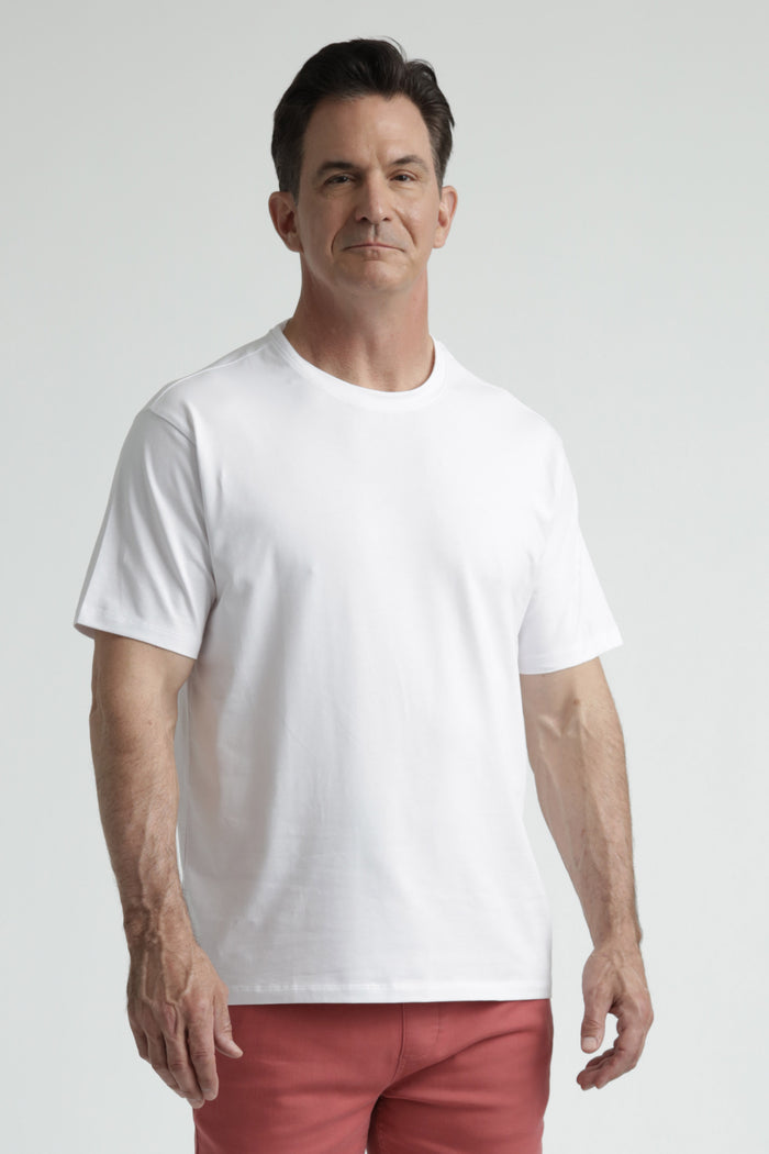 Man wearing white crew neck t-shirt with short sleeves and red shorts.