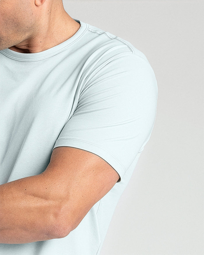 Man wearing mint crew neck t-shirt with short sleeves and crew neckline.