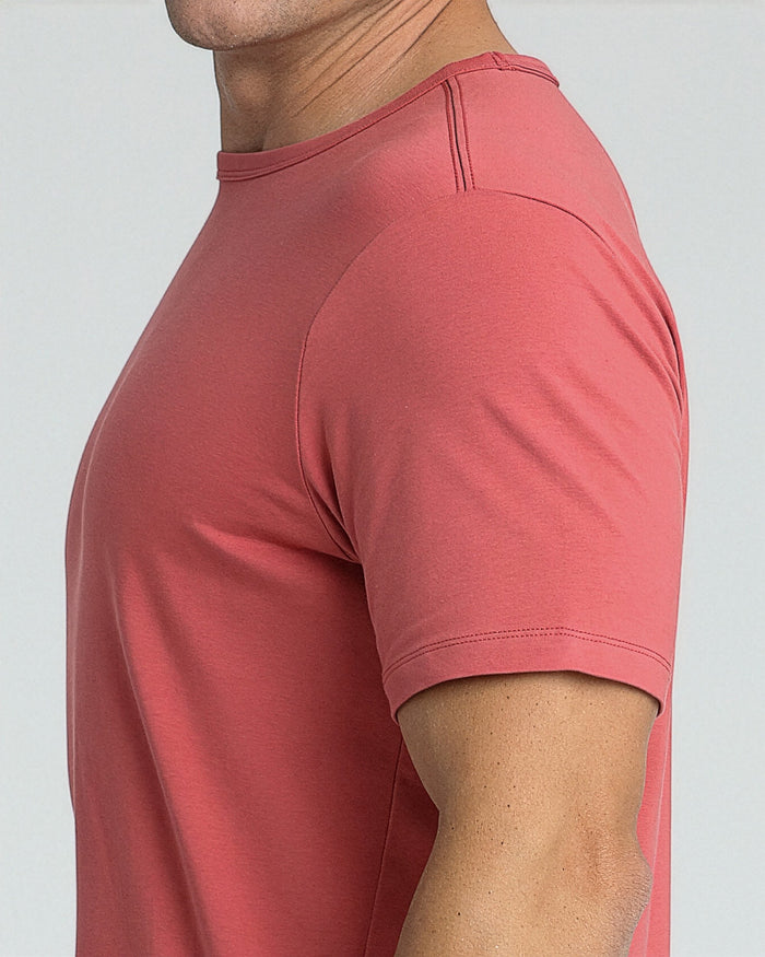 Man wearing Nantucket red crew neck t-shirt with short sleeves and visible topstitching.