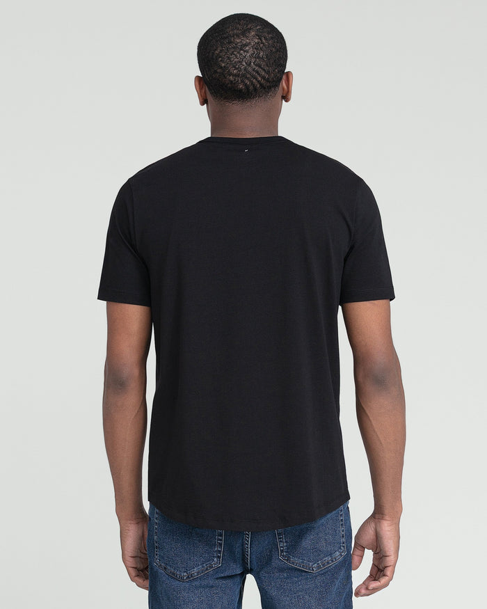 Black crew neck t-shirt with short sleeves worn with blue jeans, shown from back view.