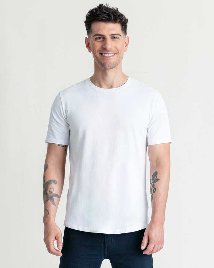 White crew neck t-shirt with short sleeves, shown on male model wearing dark jeans.