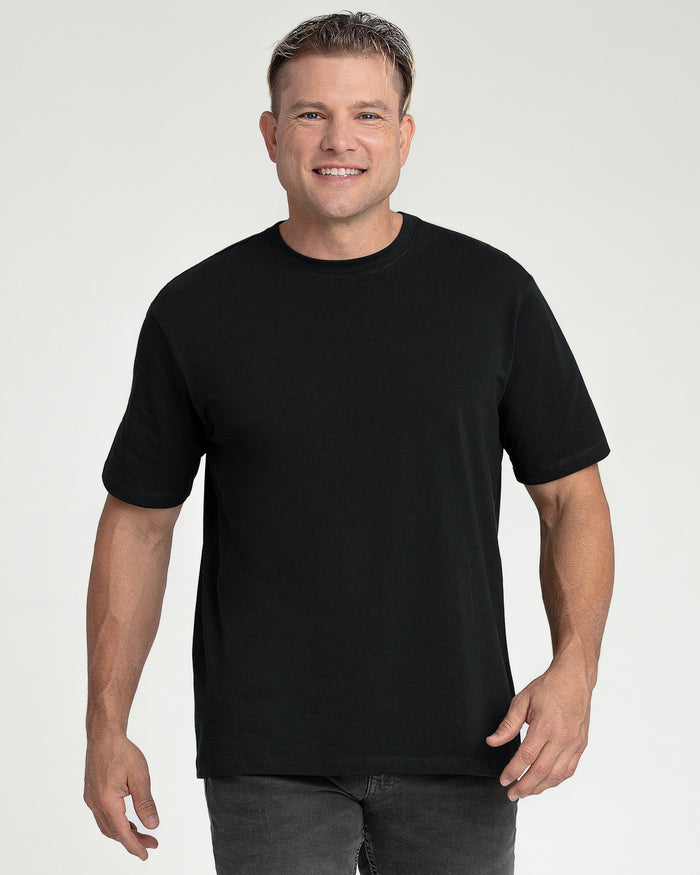 Man wearing black crew neck short-sleeve t-shirt with fitted cut and dark jeans.