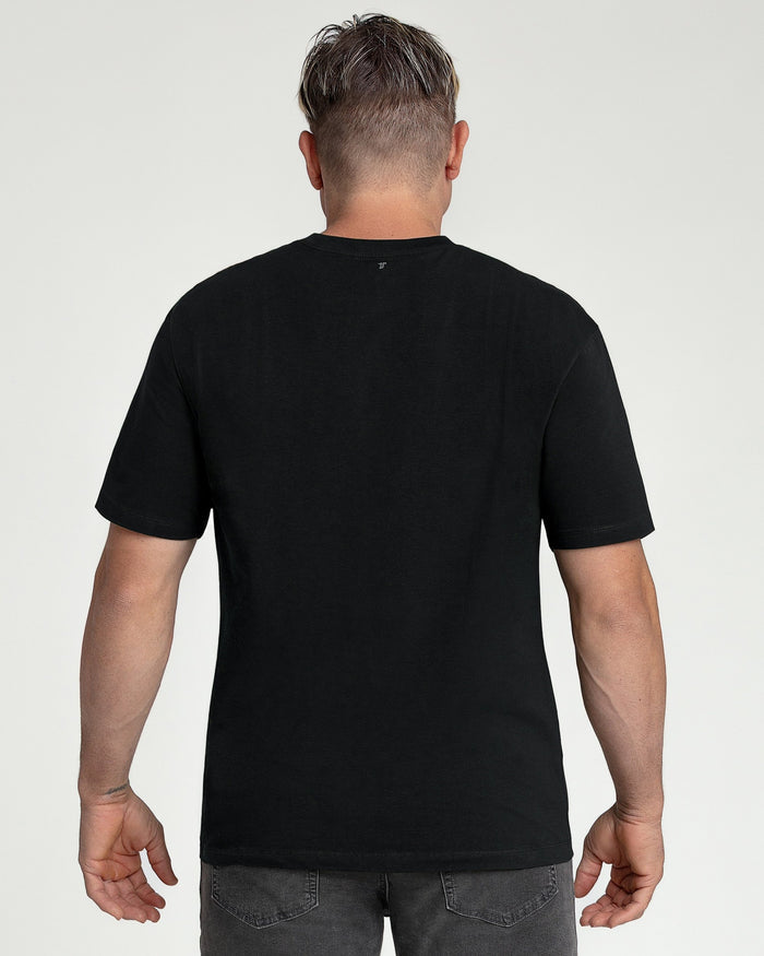 Man wearing black crew neck short-sleeve t-shirt, back view.