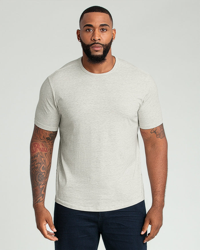 Man wearing light gray crew neck t-shirt with short sleeves and dark navy pants.