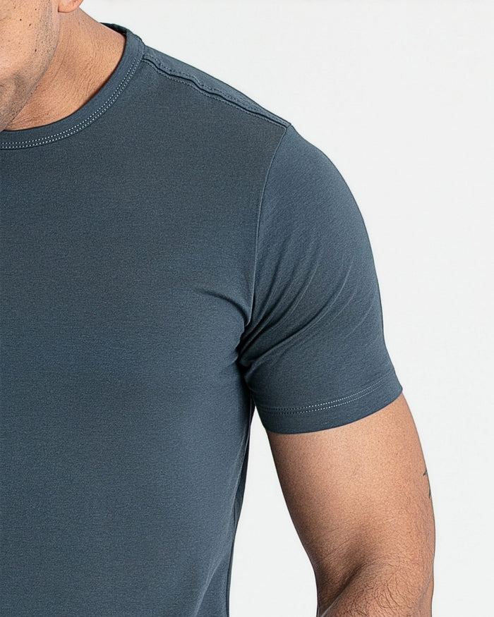 Steel blue crew neck t-shirt with short sleeves worn by a man, showing the front and shoulder detail.