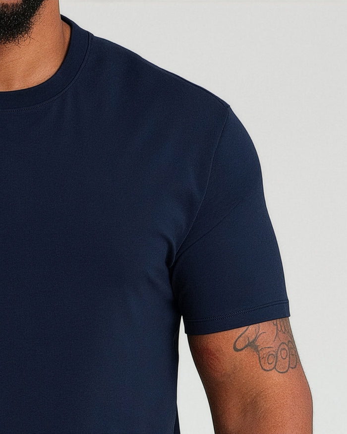 Navy crew neck t-shirt with short sleeves on a model, showing fitted athletic cut.