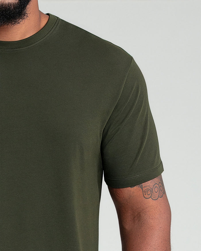 Olive green crew neck t-shirt with short sleeves on a man, shown from shoulder to mid-torso.