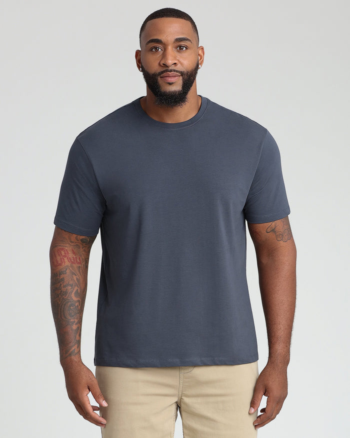 Steel gray crew neck t-shirt with short sleeves on male model wearing tan pants.
