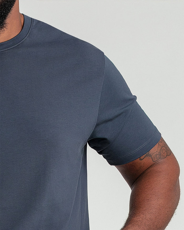 Steel gray crew neck t-shirt with short sleeves, shown on a man against a neutral background.