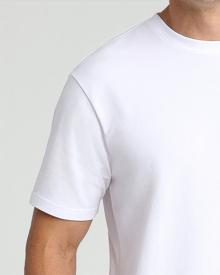 White crew neck t-shirt with short sleeves on a man, shown from chest to mid-arm against neutral background.