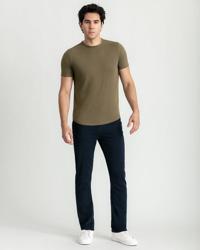 Military olive crew neck t-shirt with short sleeves on model wearing dark jeans.