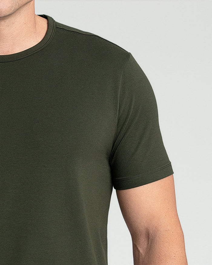 Olive green crew neck t-shirt with short sleeves on a model, showing front view and fit.