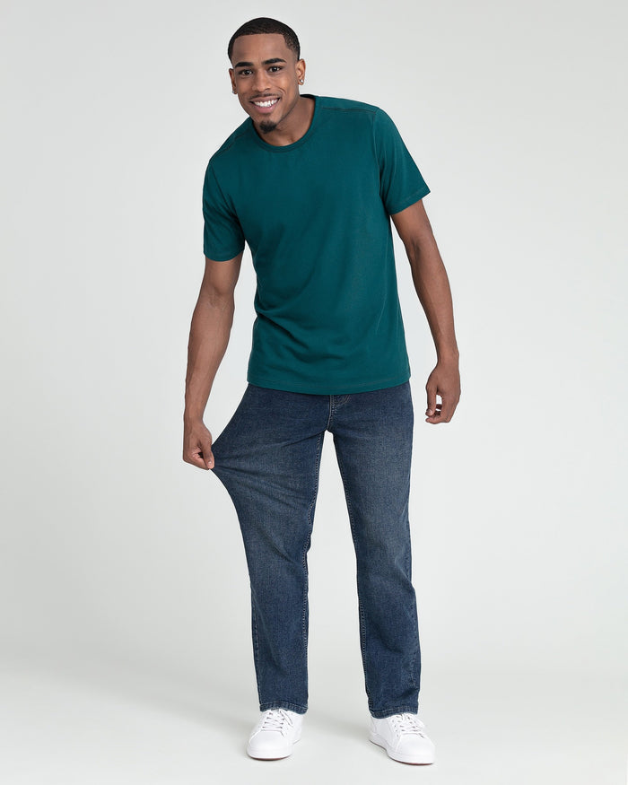 Man wearing teal crew neck t-shirt with short sleeves and blue jeans.
