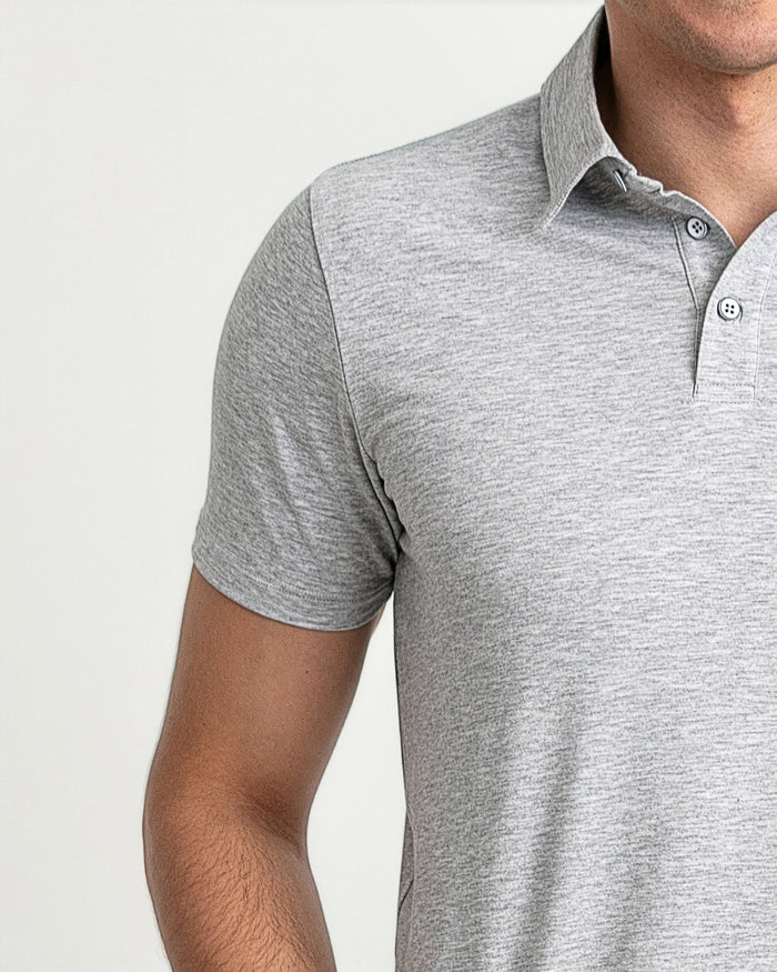 Heather grey polo shirt with short sleeves, white collar, and button placket on wearer.