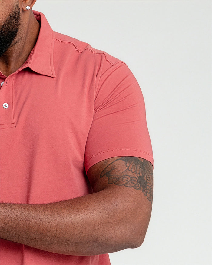 Nantucket red polo shirt with white button placket and collar, shown on male model.