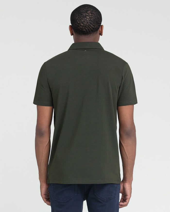 Olive green polo shirt with short sleeves and collar, shown from back on model wearing dark jeans.